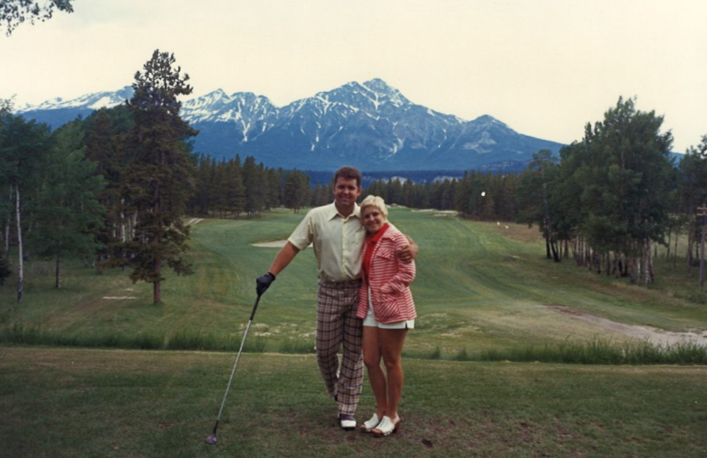 Dave and Lee on the golf course with mountains in the background