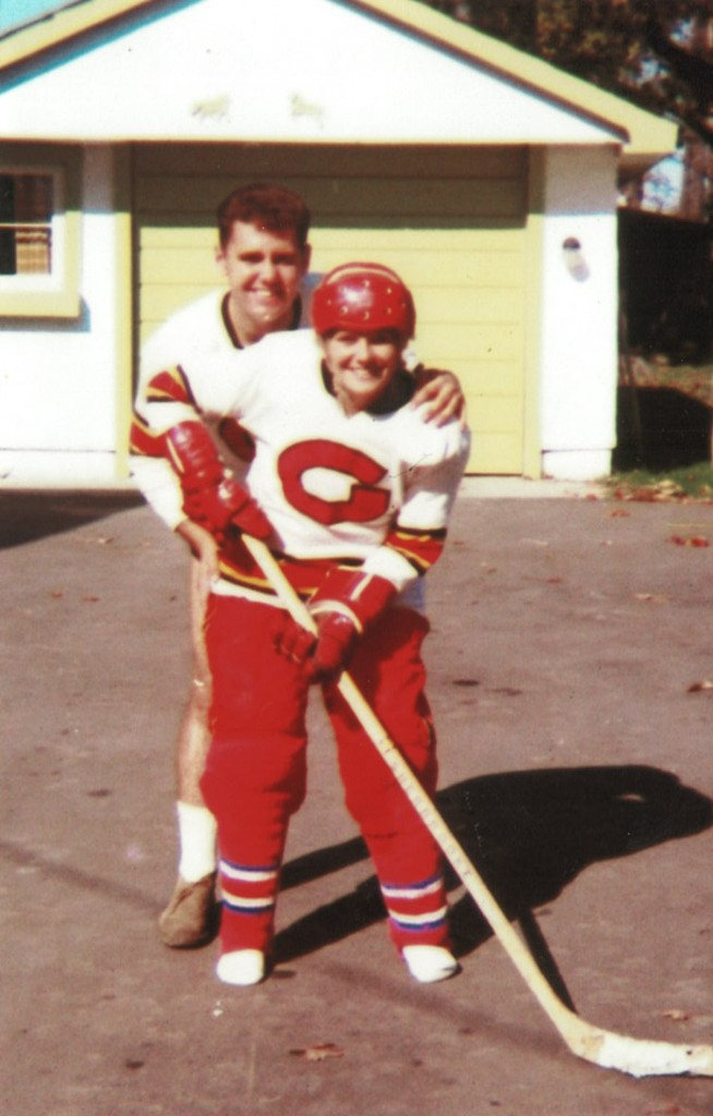 Dave in hockey gear with Lee in the driveway